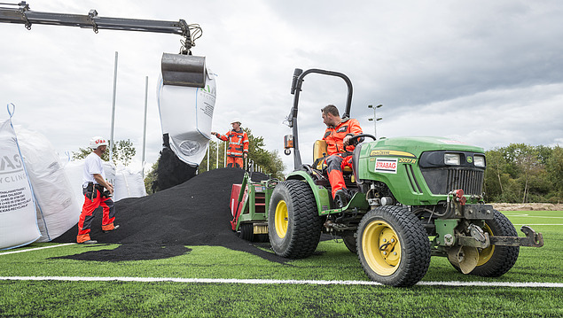 Photo of construction workers building an outdoor sports facility