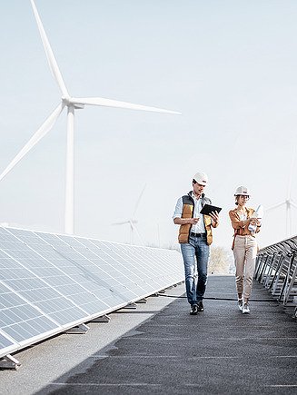 Photo of a photovoltaic system with cranes in the background